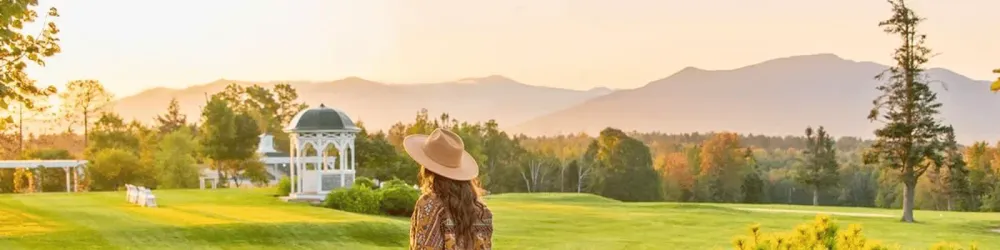 Woman with hat looking out over the grounds of the Mountain View Grand Resort and Spa